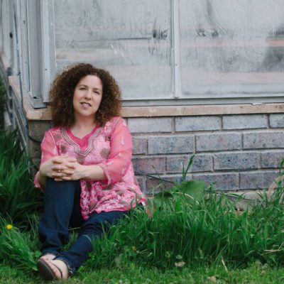 Lynne Golodner sitting on grass